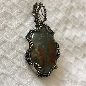 Sterling silver wrapped detailed stone pendant
